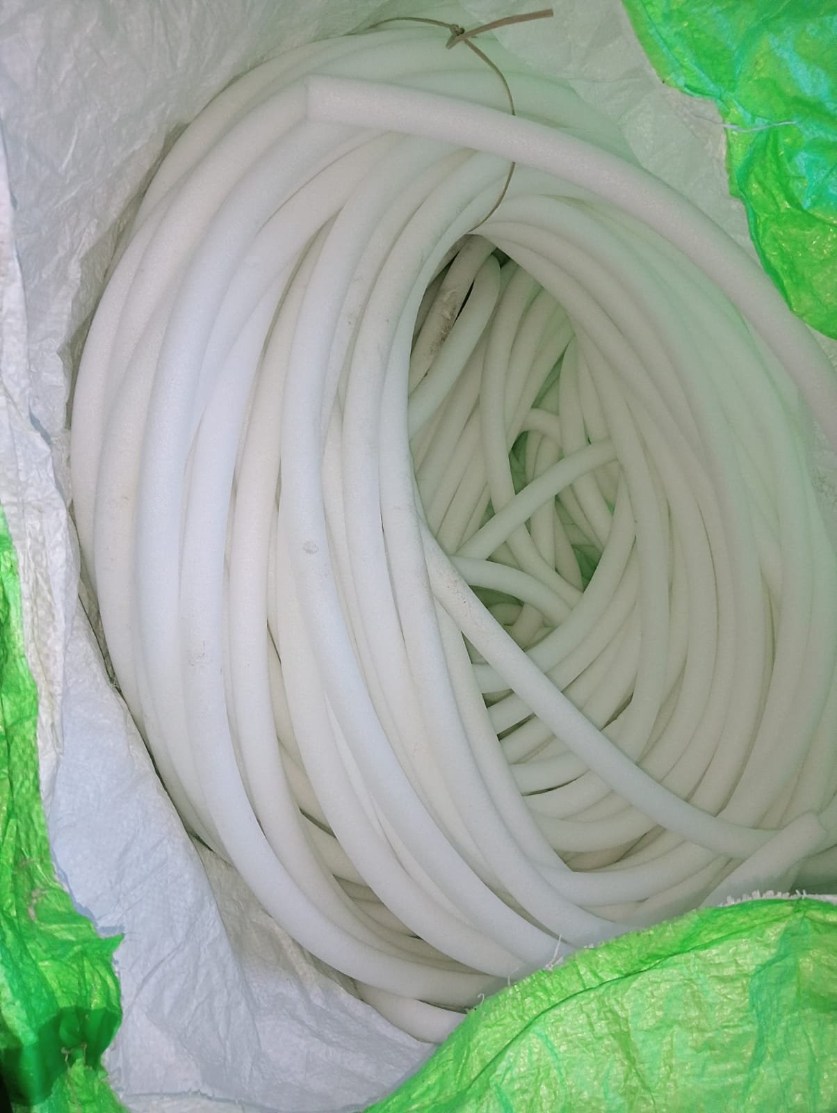 Large stacked coils of backer rod outdoors